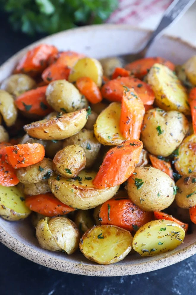 Garlic butter roasted carrots and potatoes in a bowl image