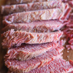 Sliced guinness corned beef on cutting board image