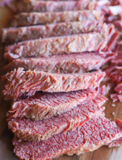 Sliced guinness corned beef on cutting board image