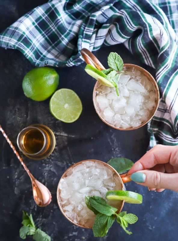 Hand holding copper mug for moscow mule