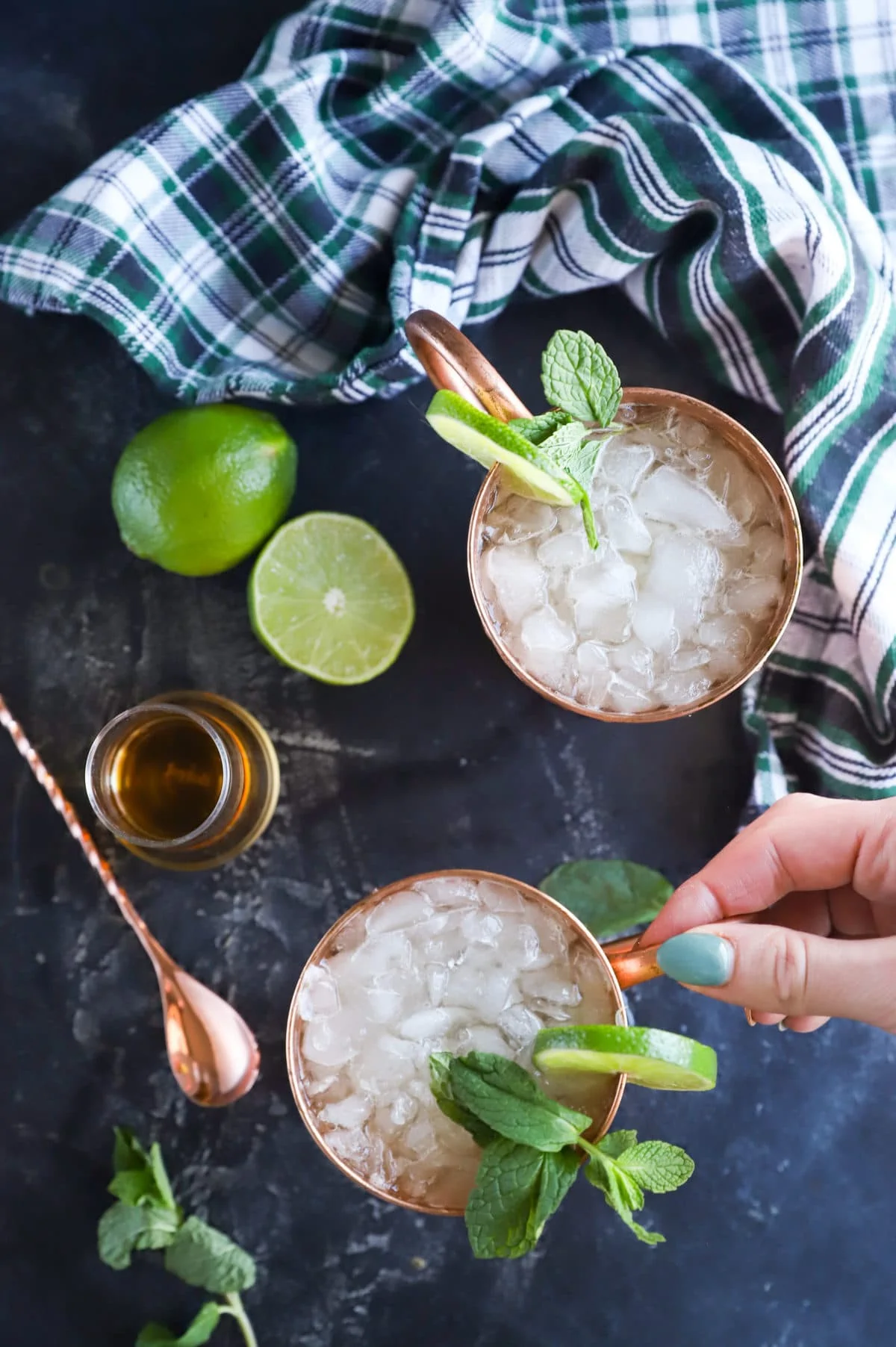 Hand holding copper mug for moscow mule