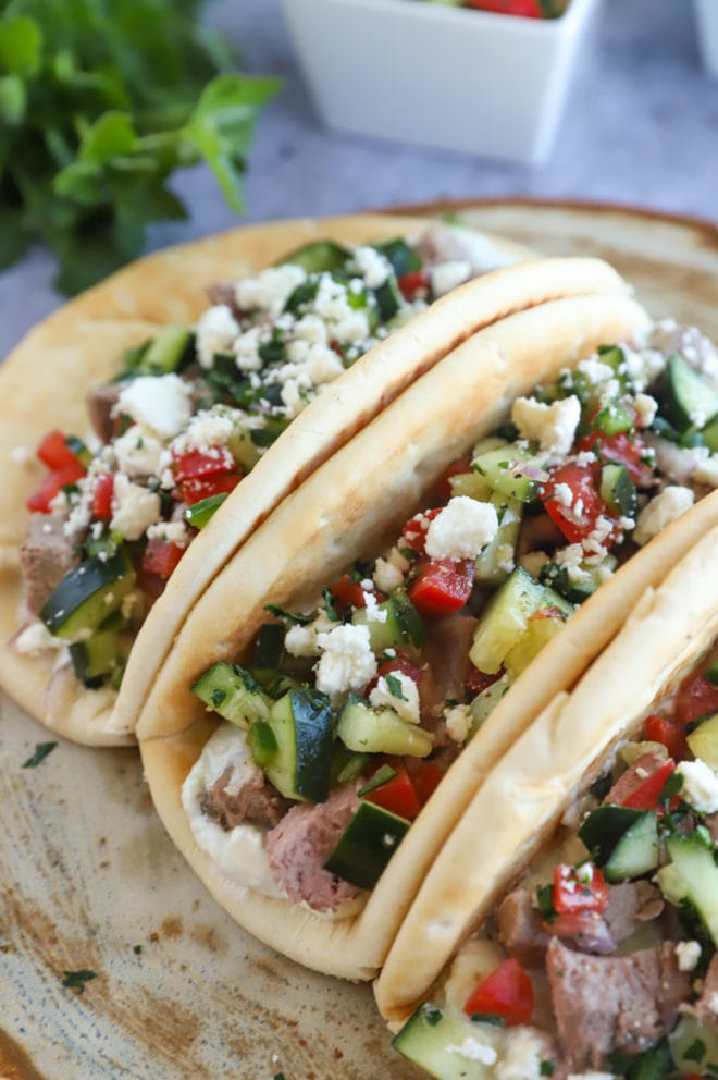 Greek gyro lamb tacos on a plate with pita image
