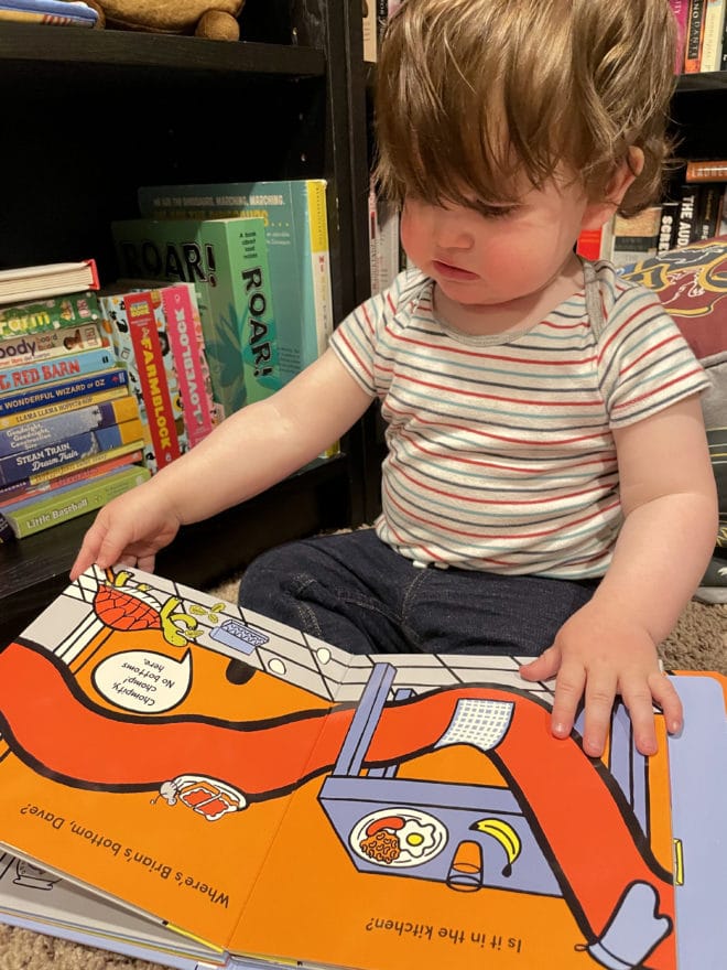 Side photo baby reading a book mother's day