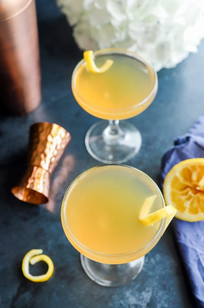 Image of bourbon cocktail with lemons and flowers