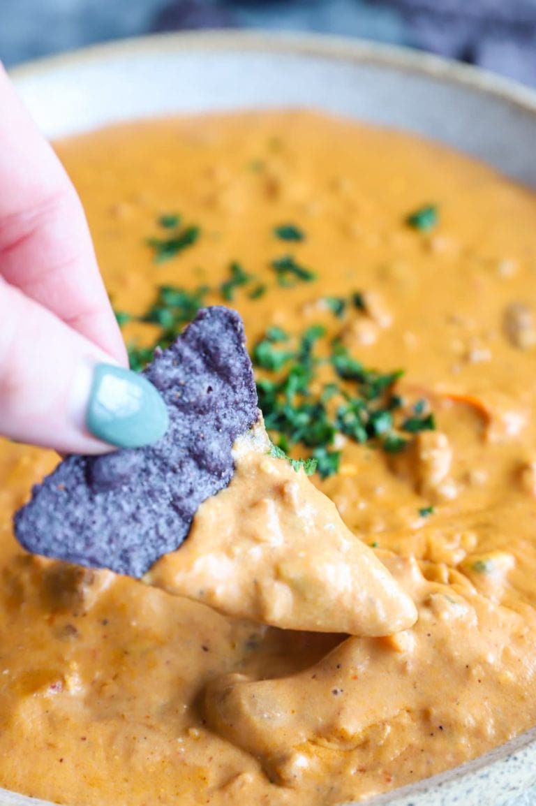 Chip dipping into queso image