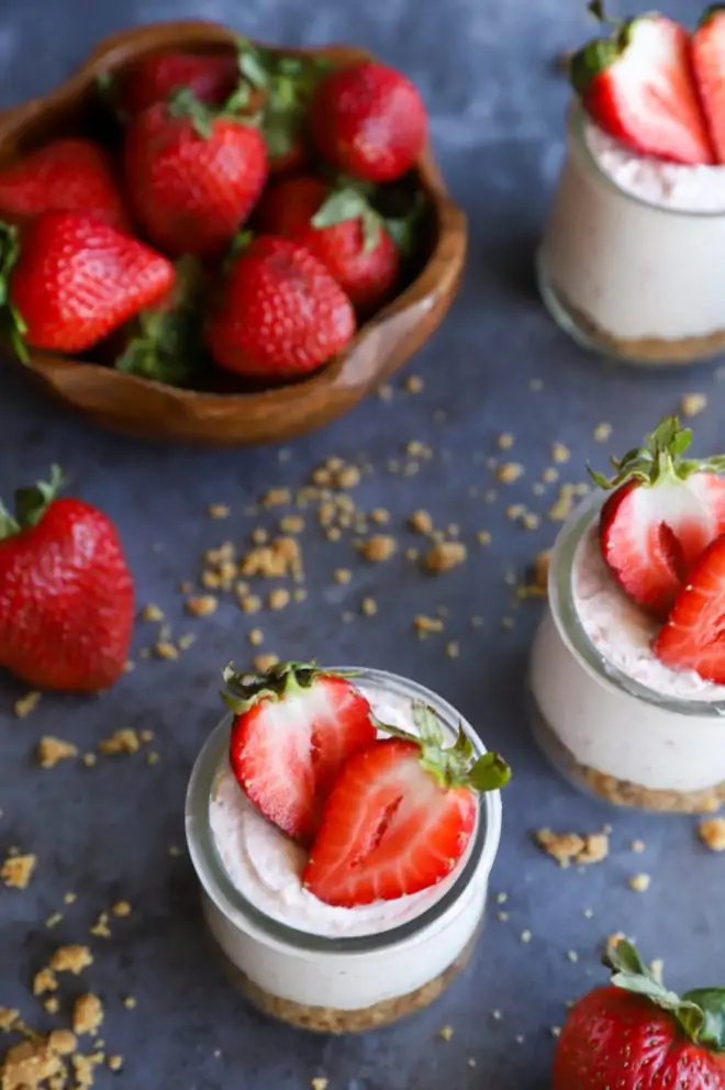 Overhead image of mousse in jars with fresh berries