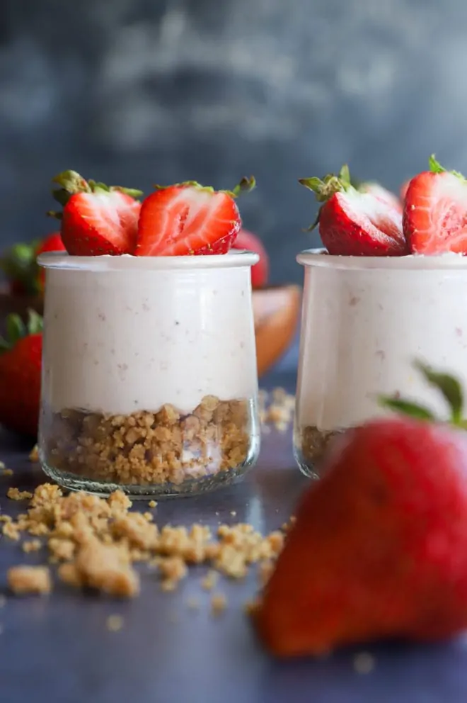 Side view of jars with mousse in them and crumble