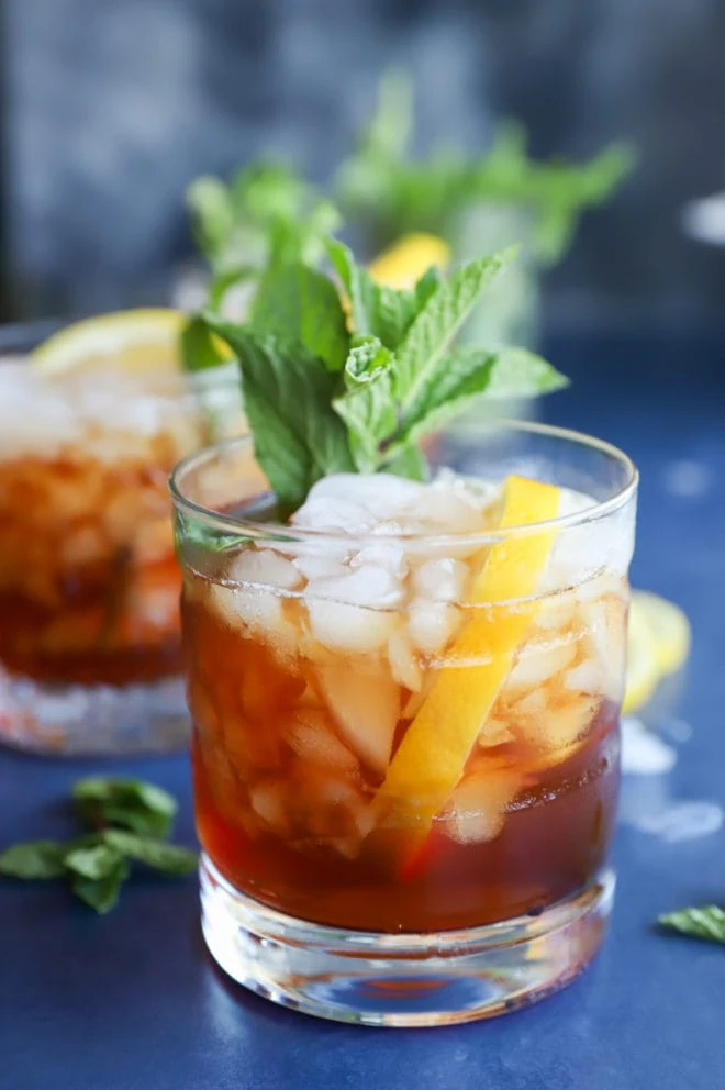 Side photo of tea cocktail in a glass with mint