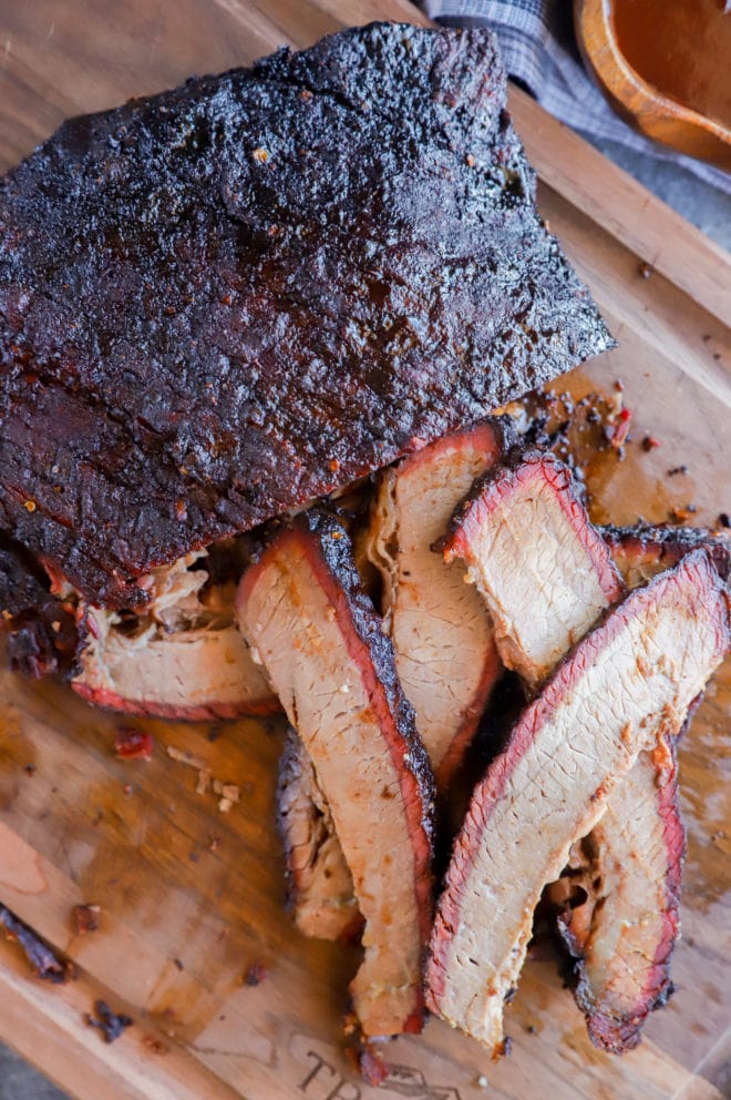 sliced smoked meat on cutting board in pile