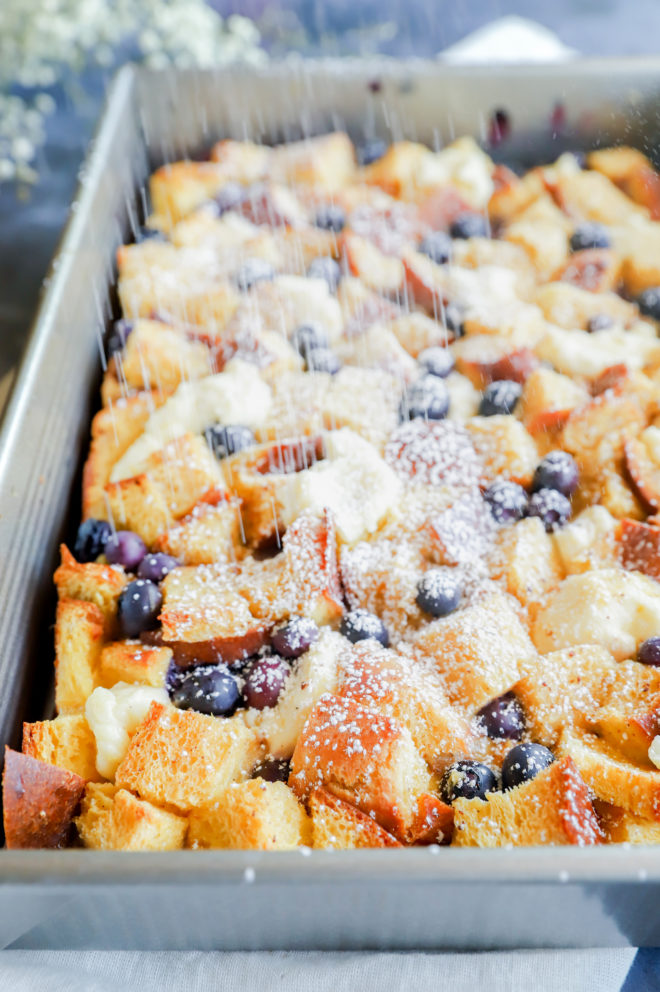 Sprinkling powdered sugar on french toast casserole image