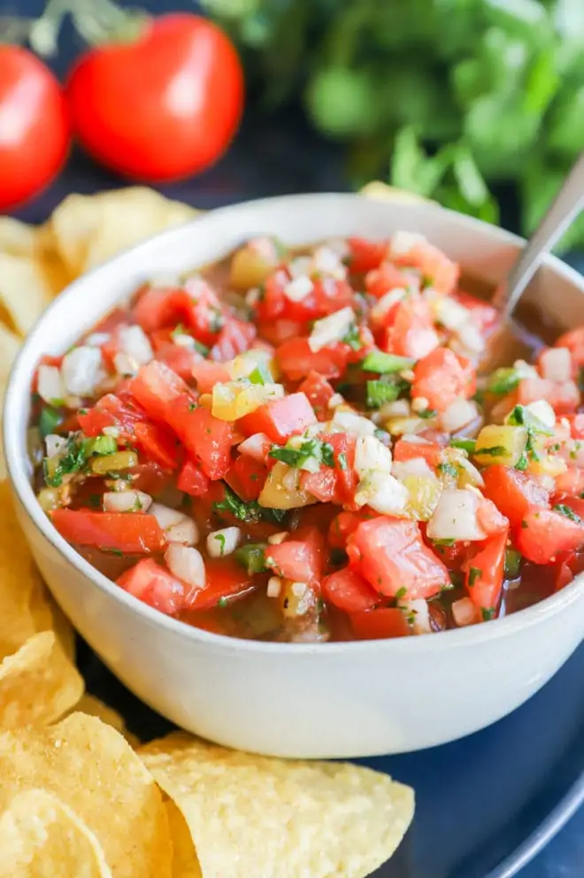 Bowl of tomatoes jalapenos onion and cilantro