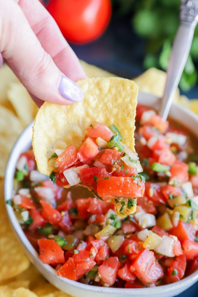 Hand holding chip with dip image