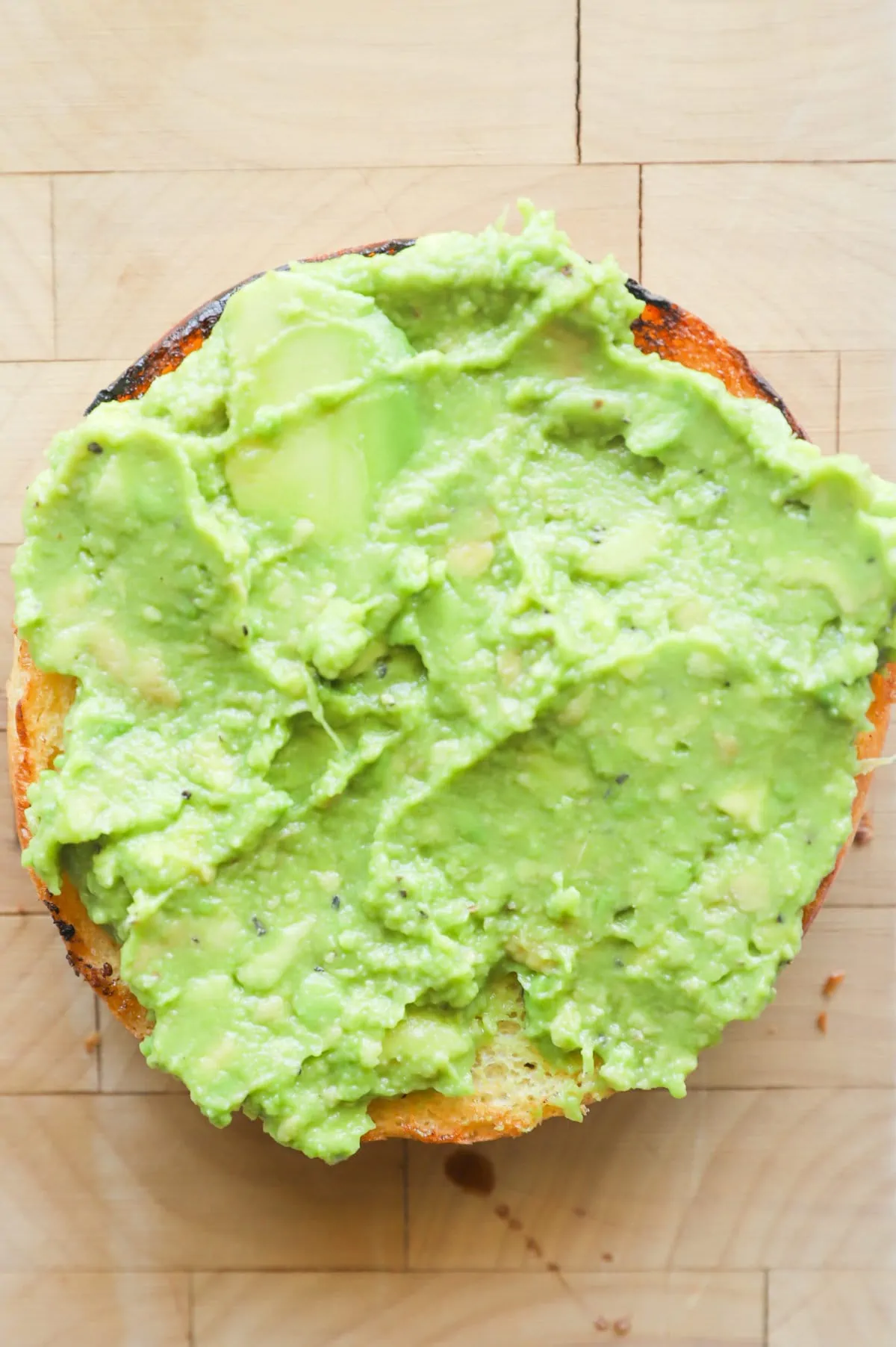 Bun with mashed avocado on top picture