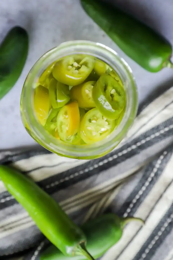 Mezcal infused with peppers in a jar picture