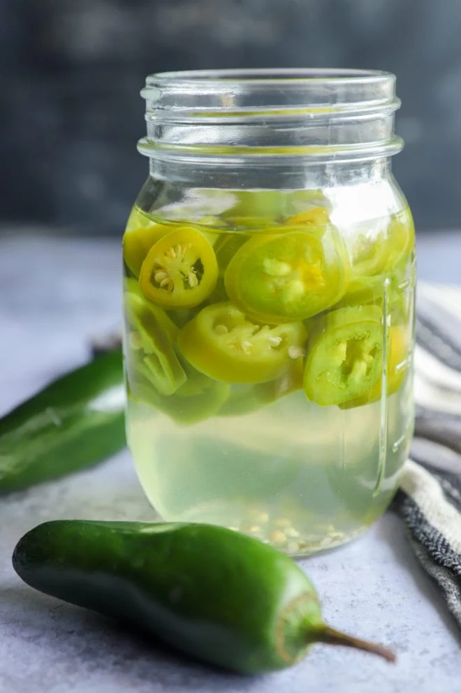 Side photo of a jar filled with spicy mezcal