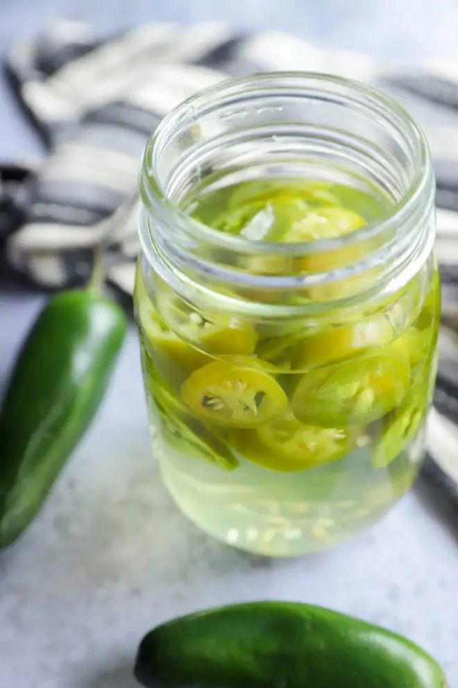 Infused mezcal with peppers in a jar image