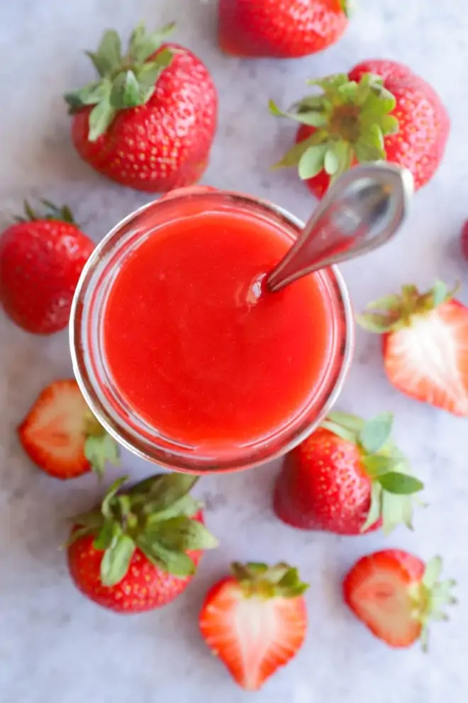 Berry sauce in mason jar with spoon