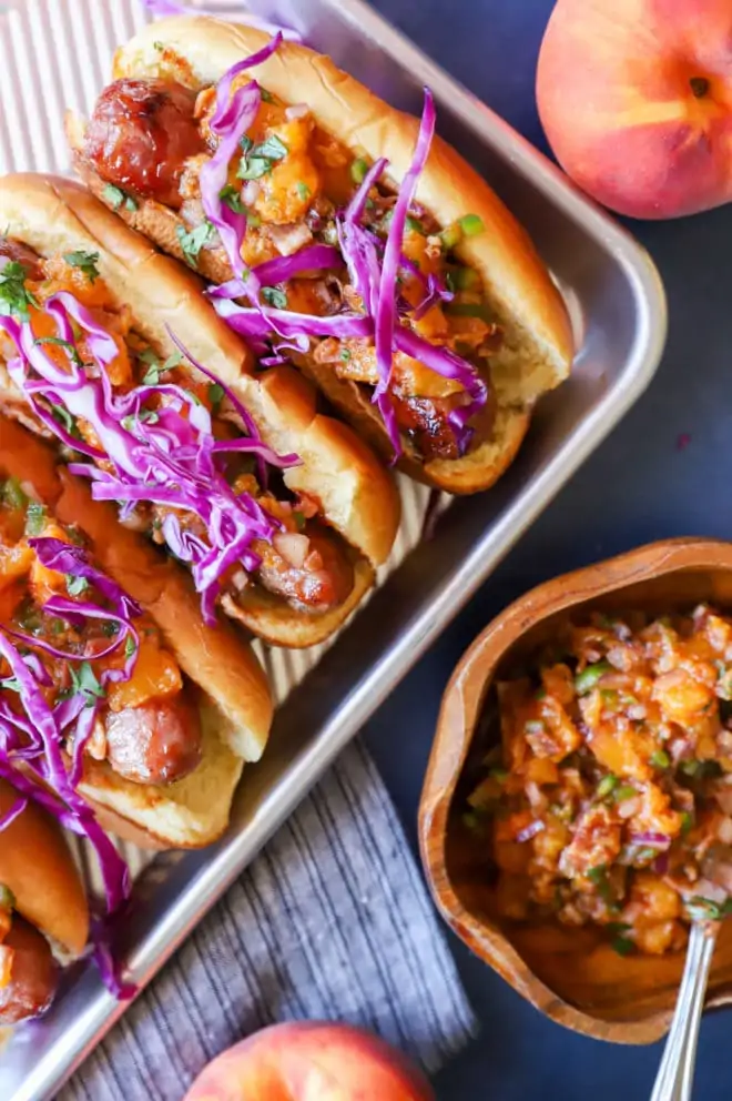 Grilled brats on sheet pan with peach salsa