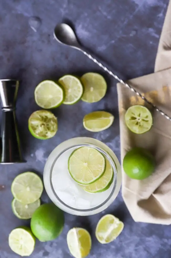 Overhead image of cocktail with limes