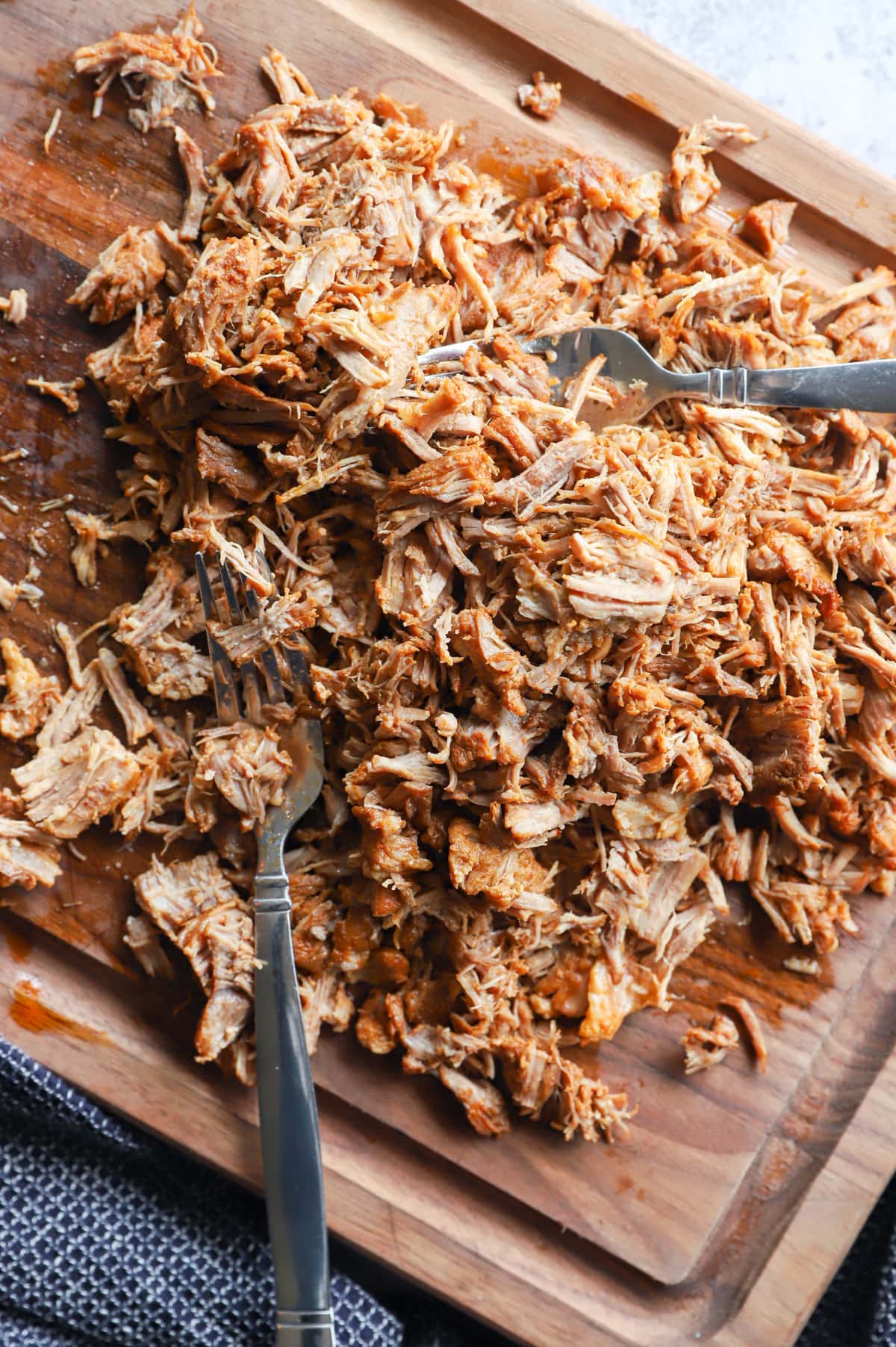 Forks shredding pork image on cutting board