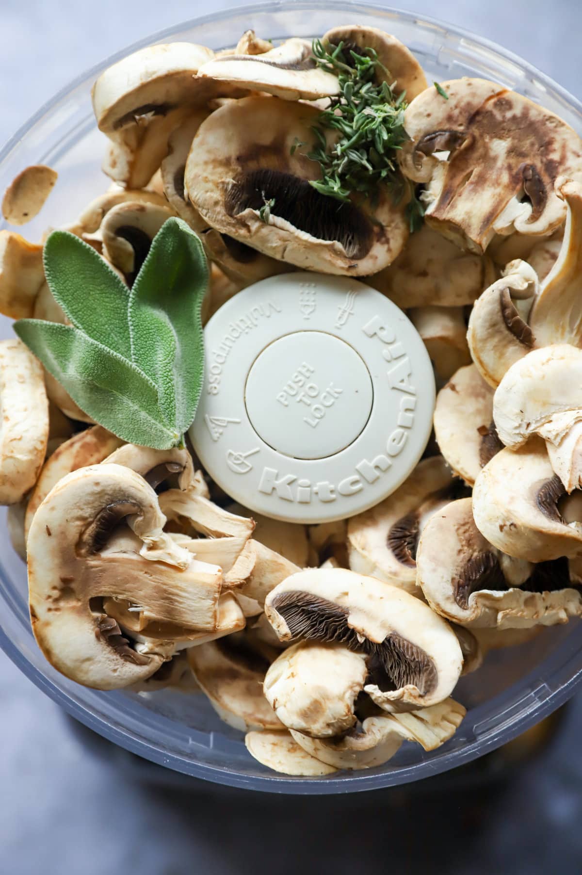 OVerhead image of mushrooms and herbs in food processor