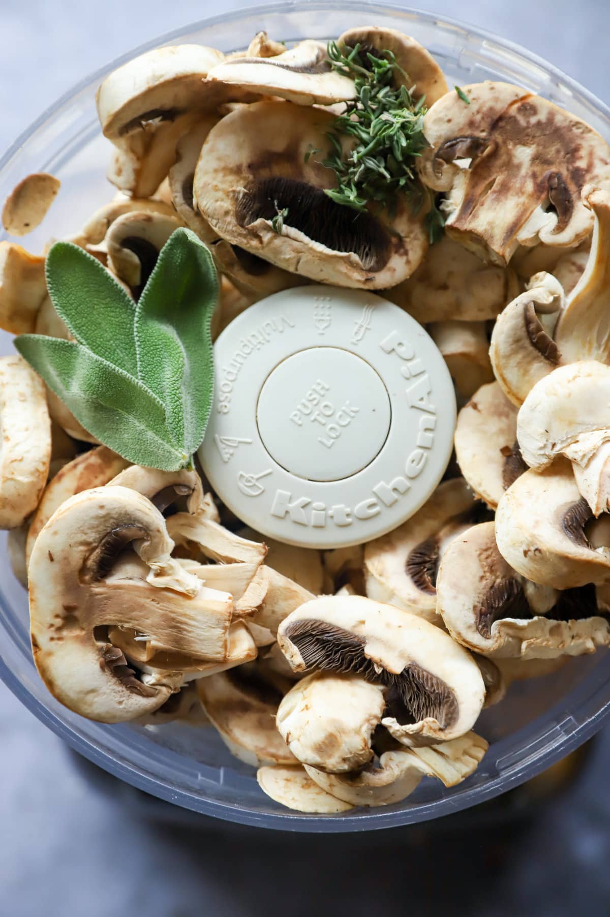 OVerhead image of mushrooms and herbs in food processor