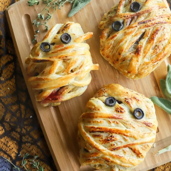 Overhead view of mummy wrapped beef on cutting board