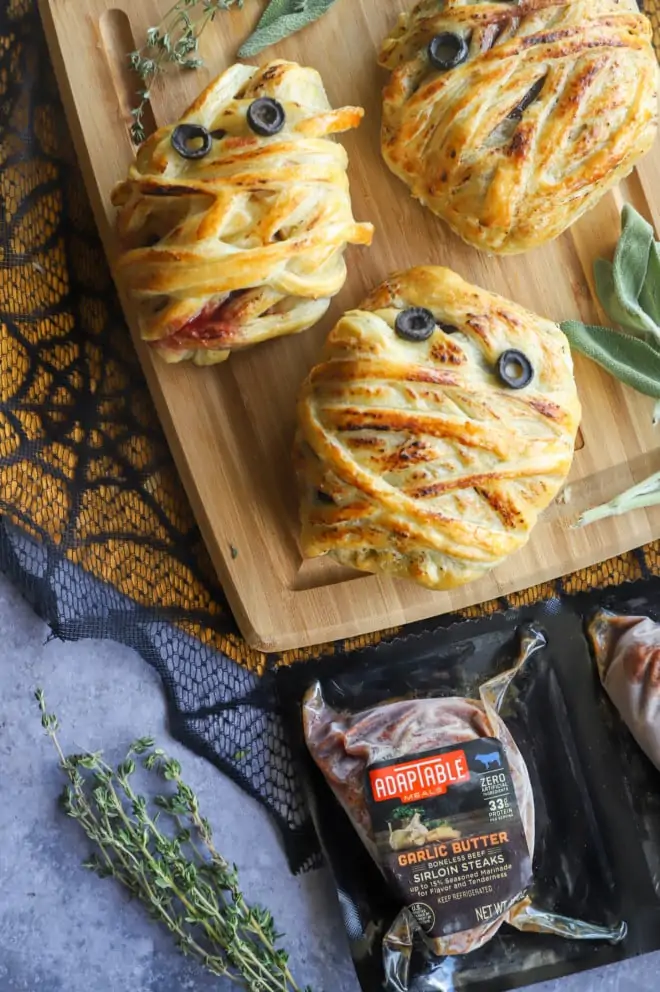 Picture of sirloin wellingtons on cutting board with meat