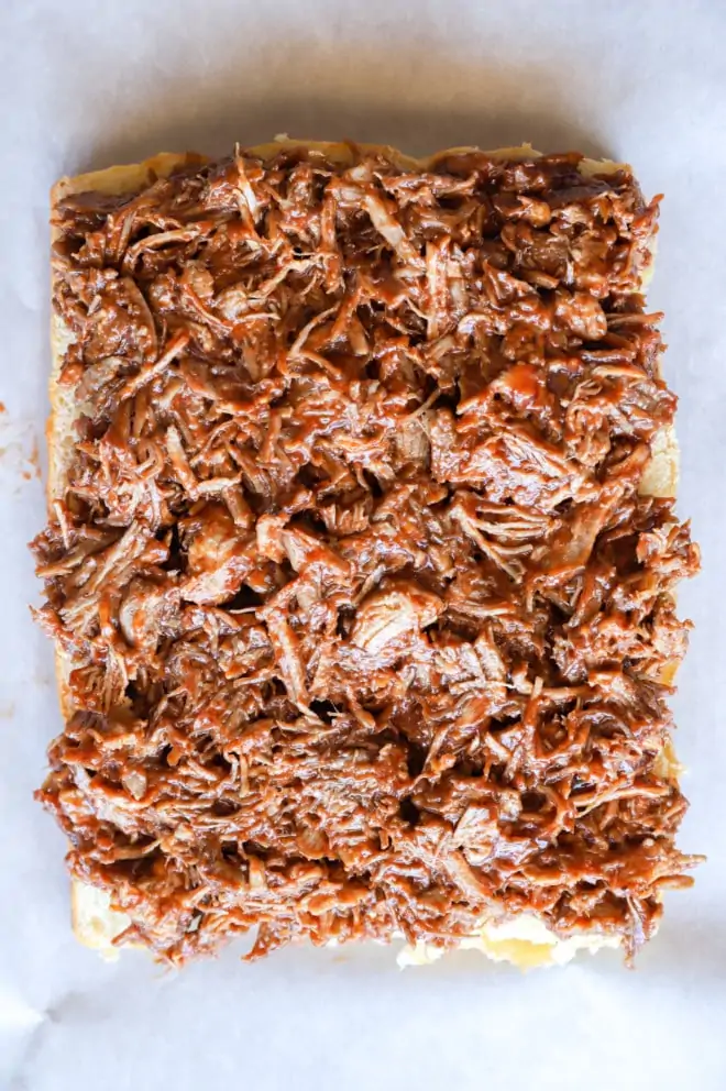 Pulled pork on buns on baking sheet image