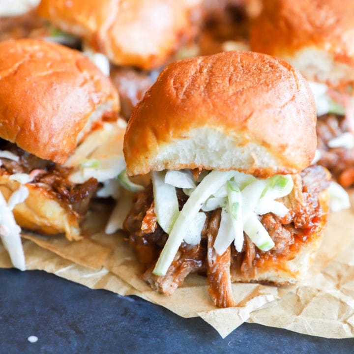 Photo of sliders on parchment paper with coleslaw