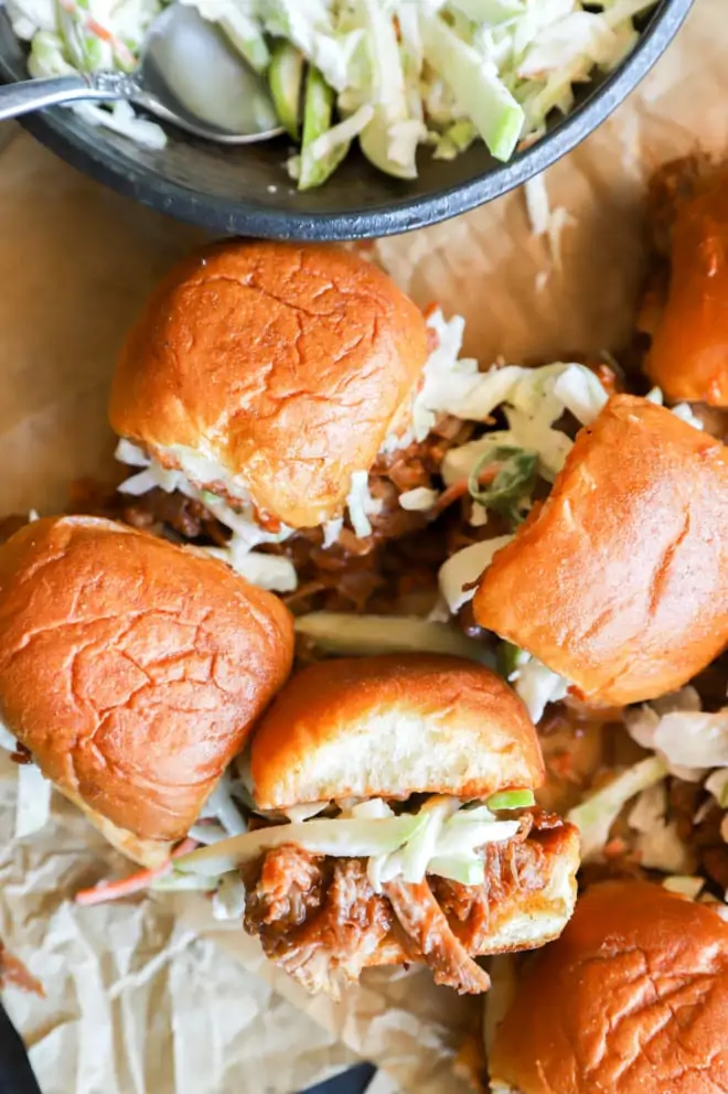 Overhead image of pulled pork sliders and apple coleslaw