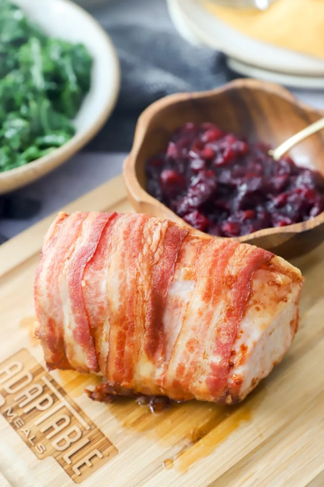 Pork and roasted cranberries on cutting board image
