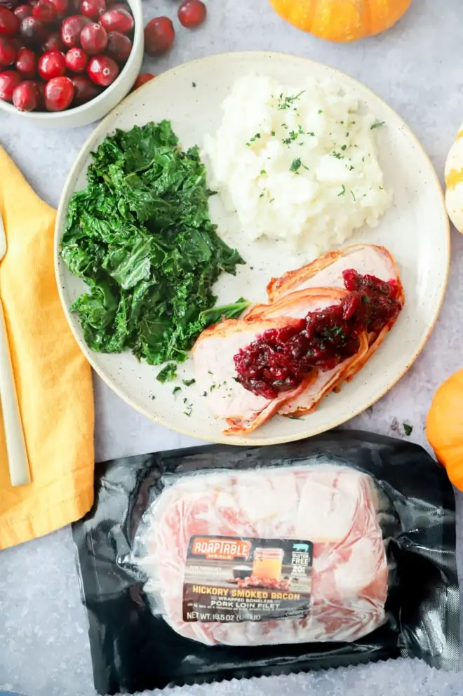 Image of pork with potatoes and kale and cranberries