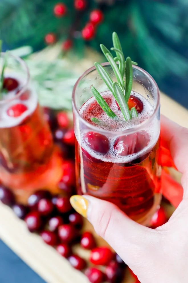 Hand holding champagne flute with cocktail image