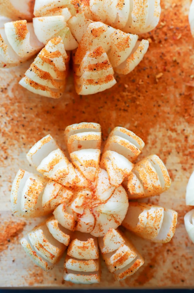 Overhead image of cut onion on cutting board