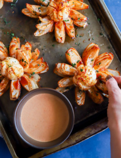 Hand taking a piece of a blooming onion