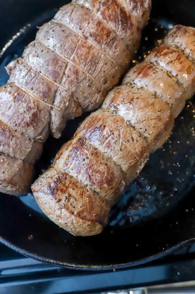 beef tenderloin in cast iron skillet image