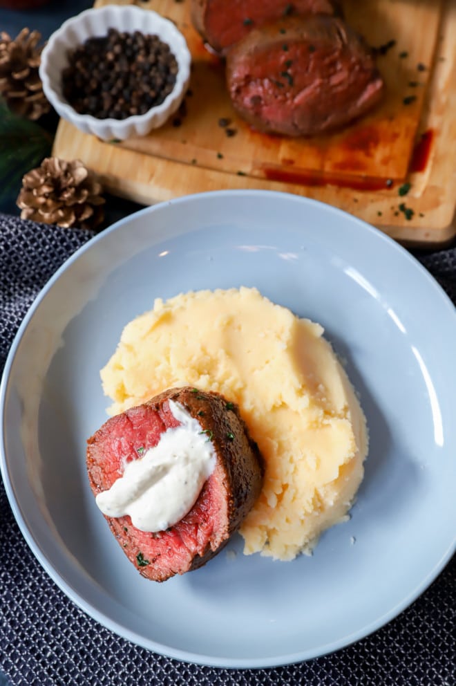 plate of mashed potatoes and steak with horseradish