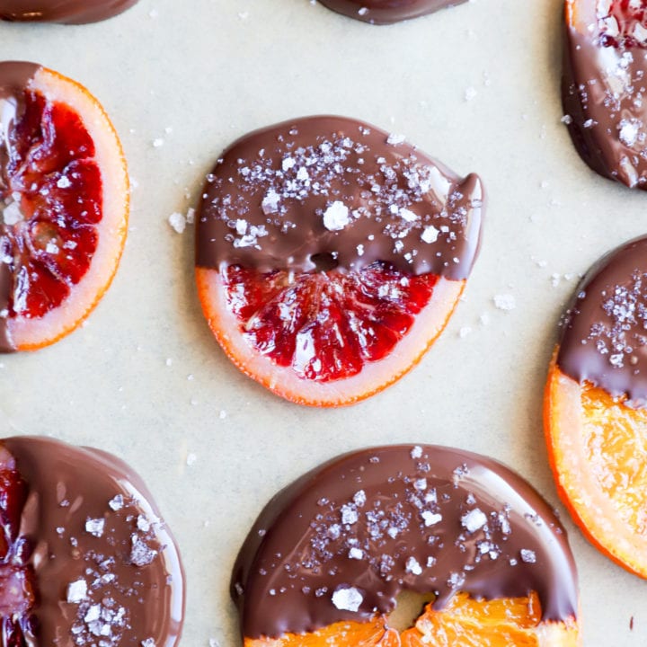 Image of chocolate dipped orange slices on parchment