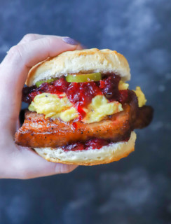 Hand holding pork belly sandwich image