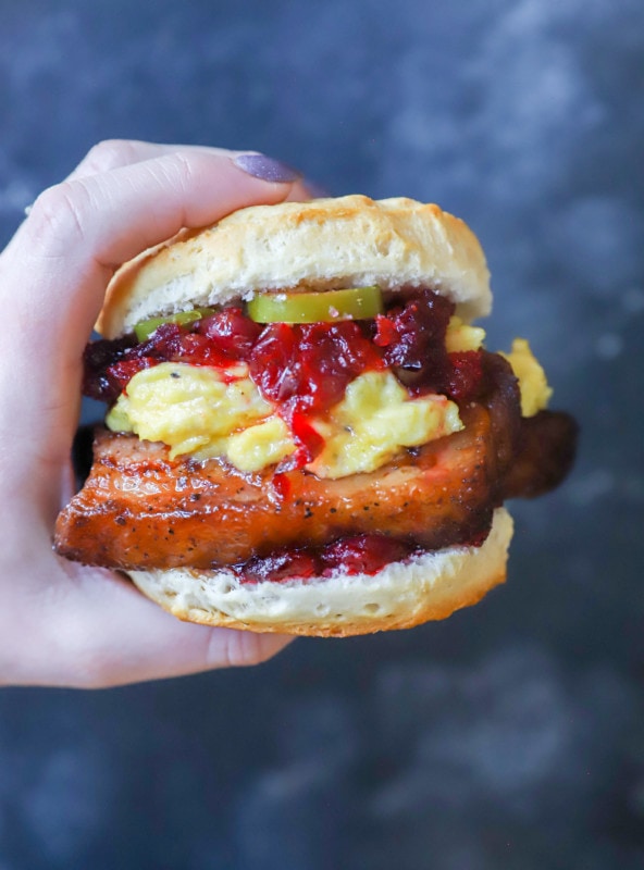 Hand holding pork belly sandwich image