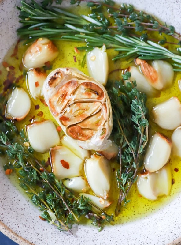 Overhead image of roasted garlic in a bowl