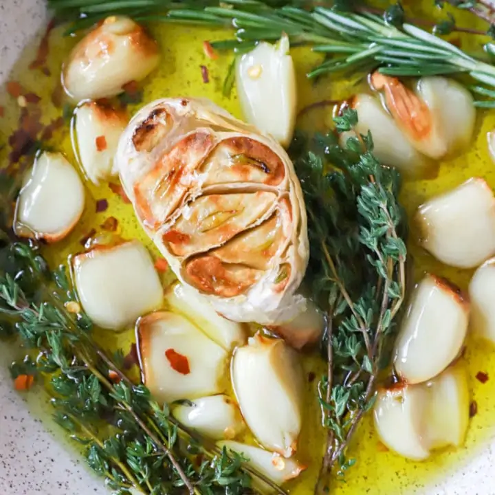 Overhead image of roasted garlic in a bowl