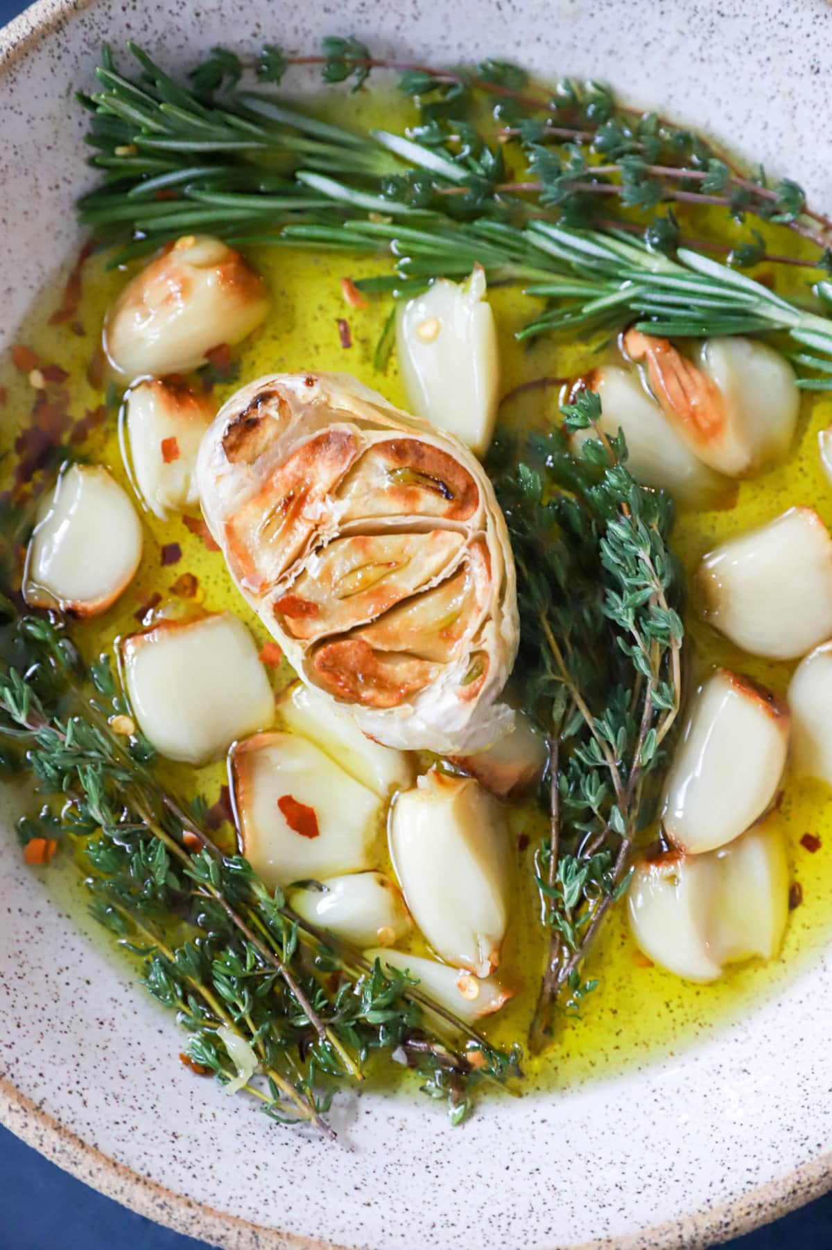 Overhead image of roasted garlic in a bowl