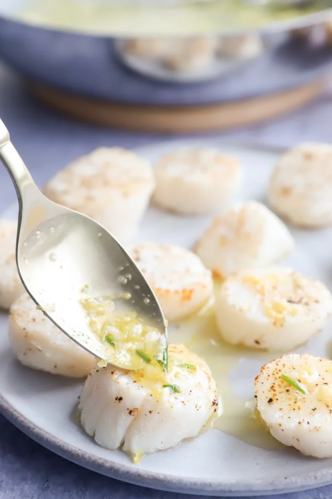 Drizzling seafood with chive lemon butter