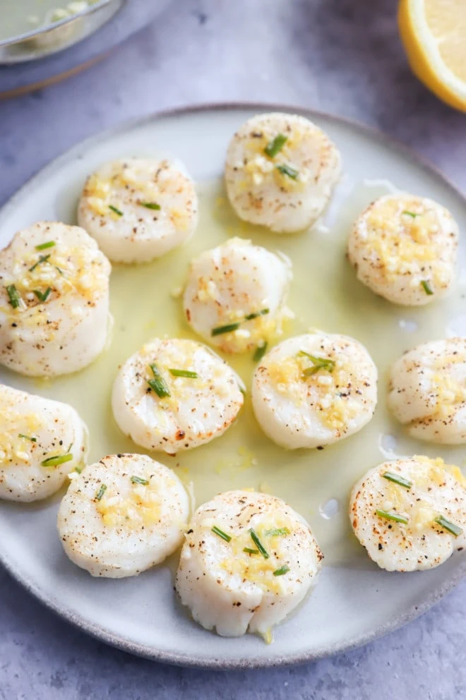 Air fryer scallops on a plate with chive butter