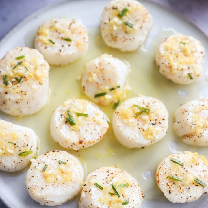 Air fryer scallops on a plate with chive butter