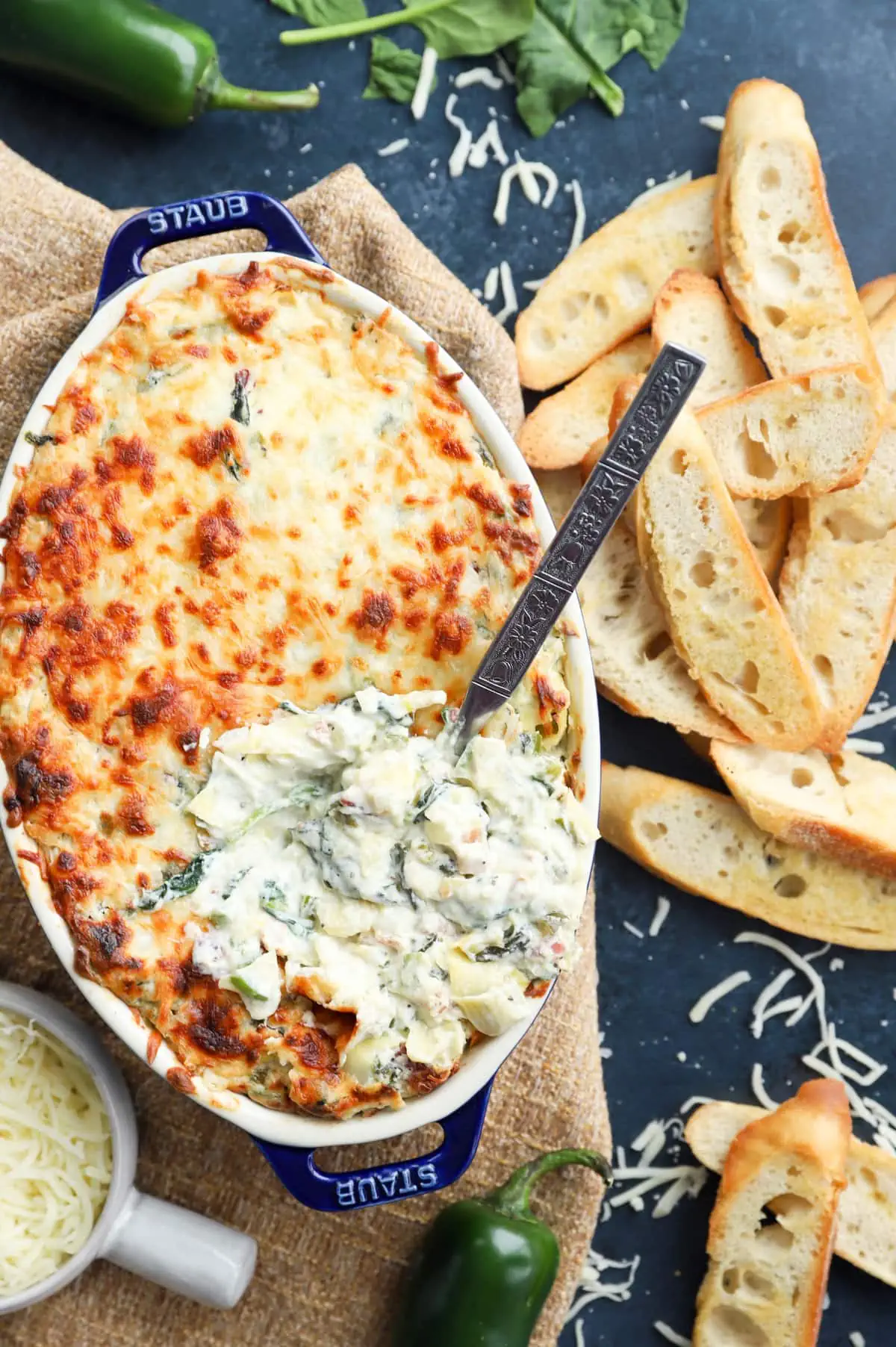 Overhead image of bacon jalapeno spinach artichoke baking dish