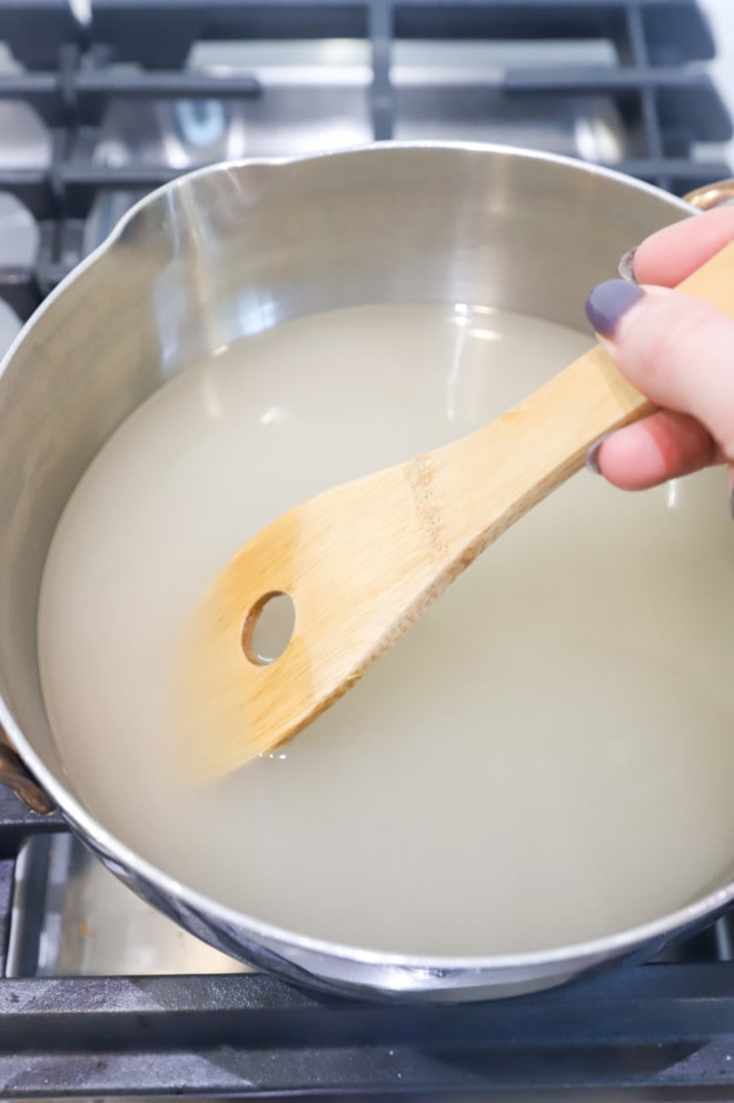 Stirring sugar mixture in a saucepan photo
