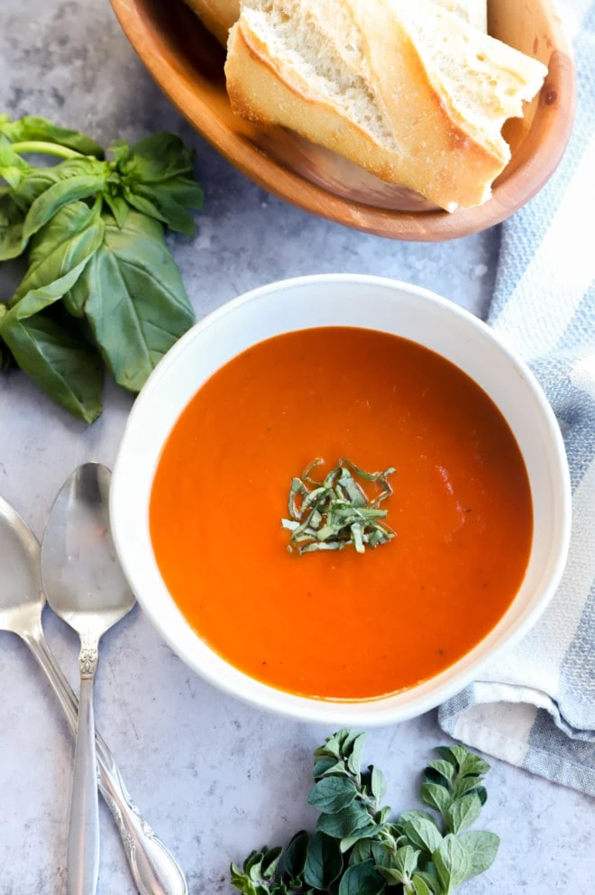 Photo of winter comfort food in bowl with basil and bread